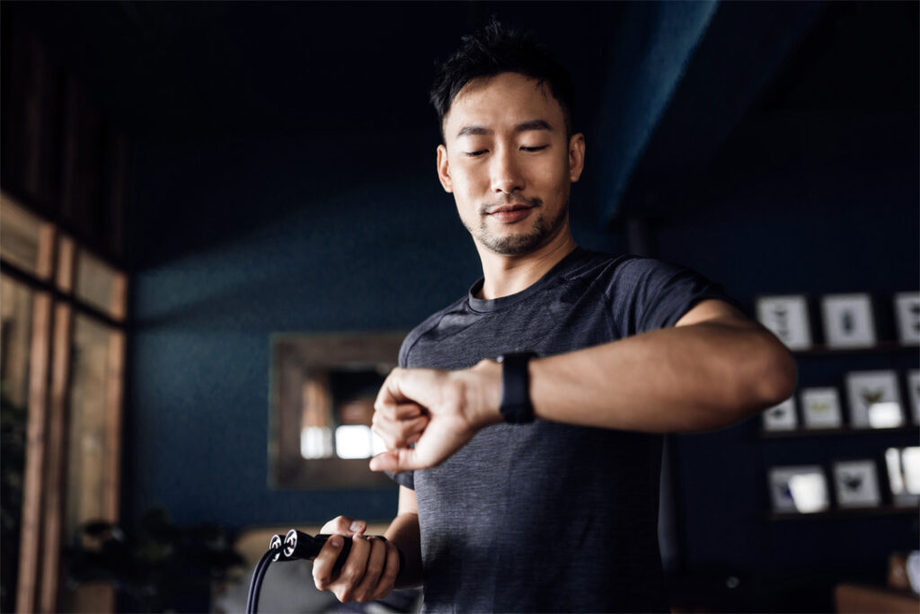 Active young Asian man exercising at home